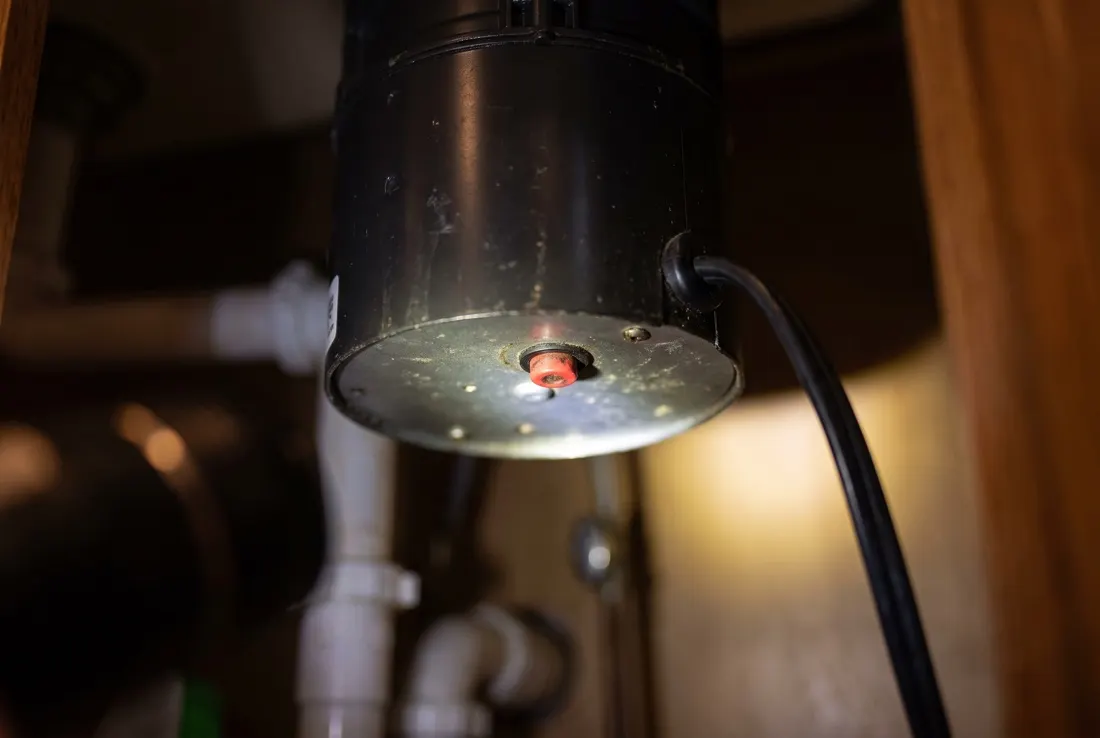 The red reset button, on the bottom of the unit