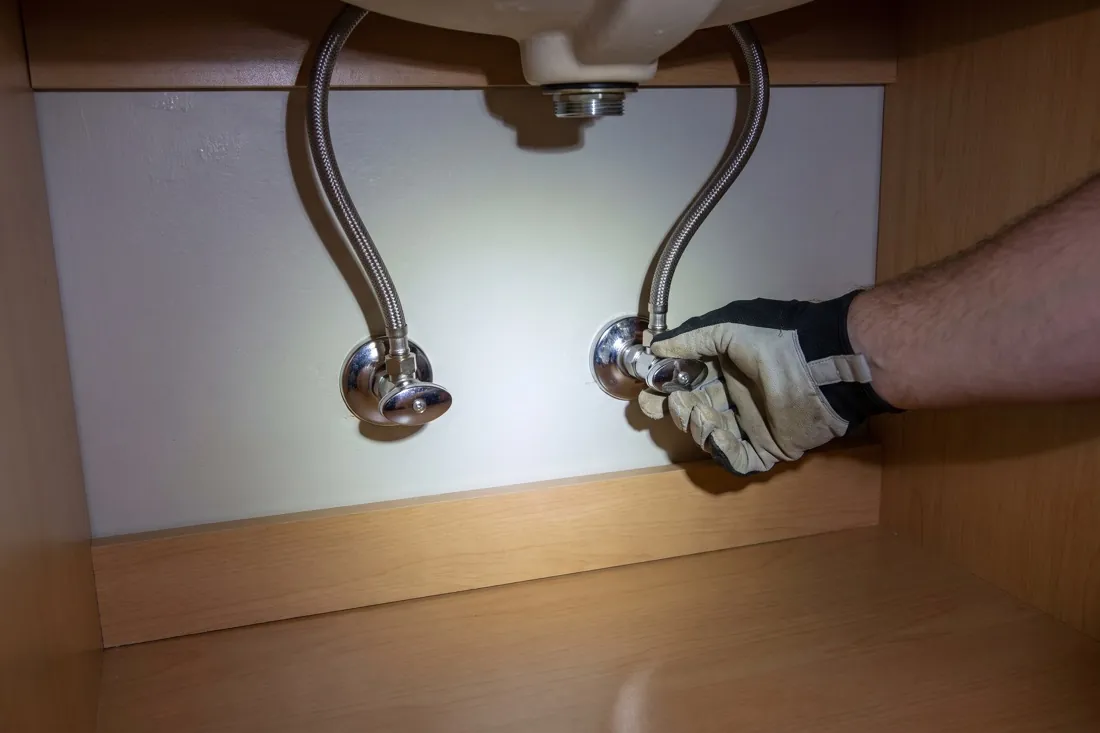 Turning an angle stop valve under a bathroom sink