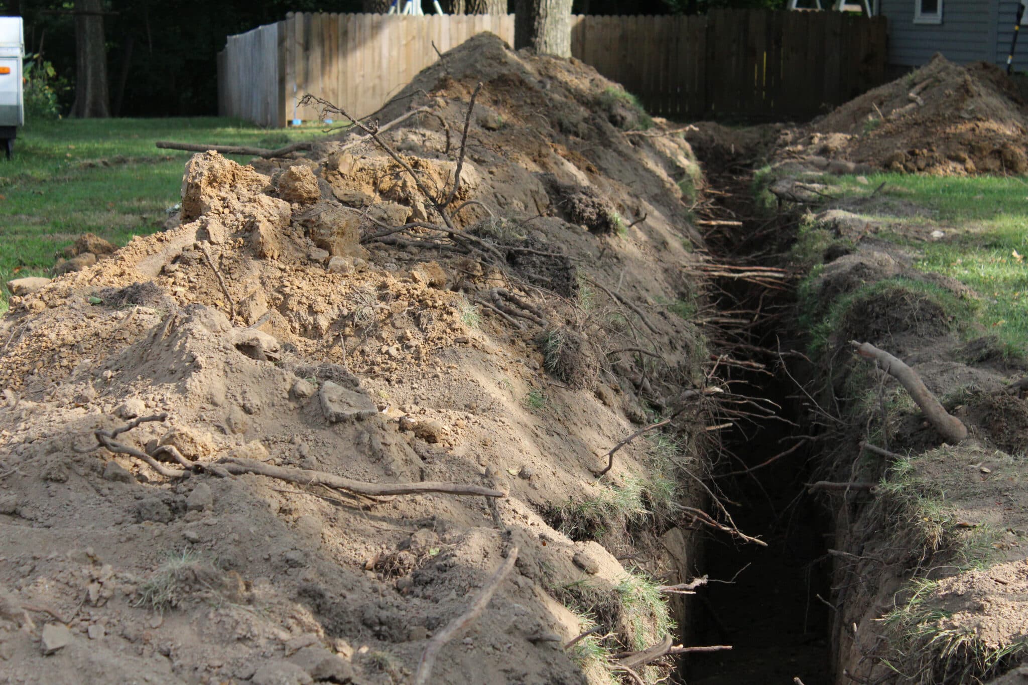 Home lawn trench, excavation, putting in a new water line, Pipe bursting.